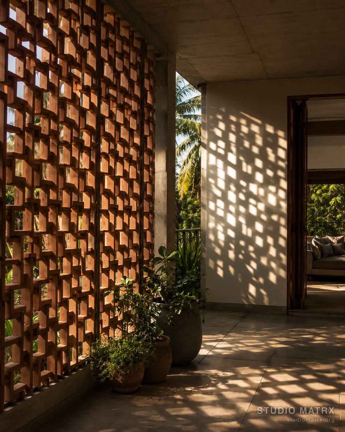 Sunlight filtering through a perforated brick jaali screen into a shaded verandah